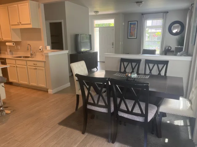 Kitchen with light cabinetry and solid surface countertops