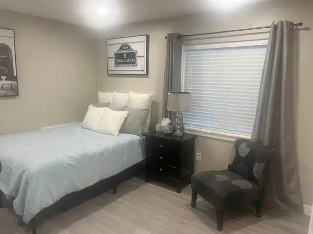 Neutral wall color, recessed lighting, and wood-finish flooring