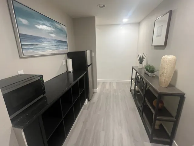 Built-in cabinetry with open shelving, integrated refrigerator, and recessed lighting