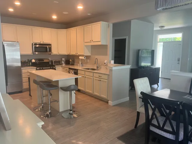 Kitchen featuring cream cabinetry, stainless steel appliances, and a central island