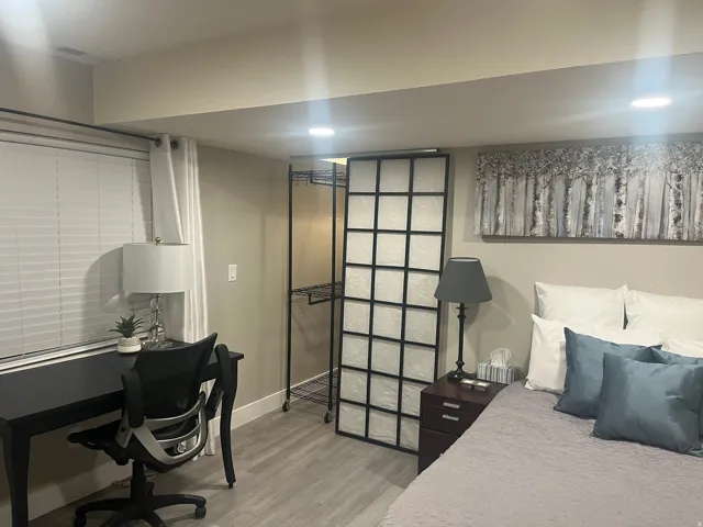 Recessed lighting, wood-finish flooring, and white window blinds