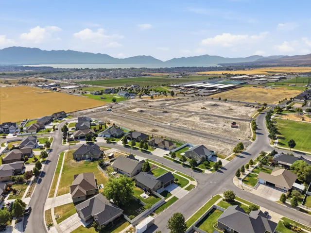 Expansive residential community featuring established homes, undeveloped parcels, paved roadways, and green spaces