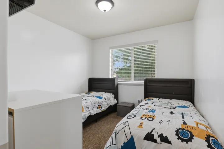 Recessed window with blinds, white walls, and a ceiling-mounted light fixture