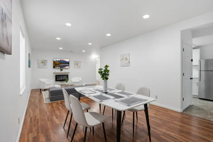 Recessed lighting, wood-finish flooring, and white painted walls