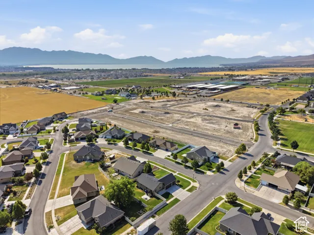 Expansive residential community featuring established homes, undeveloped parcels, paved roadways, and green spaces