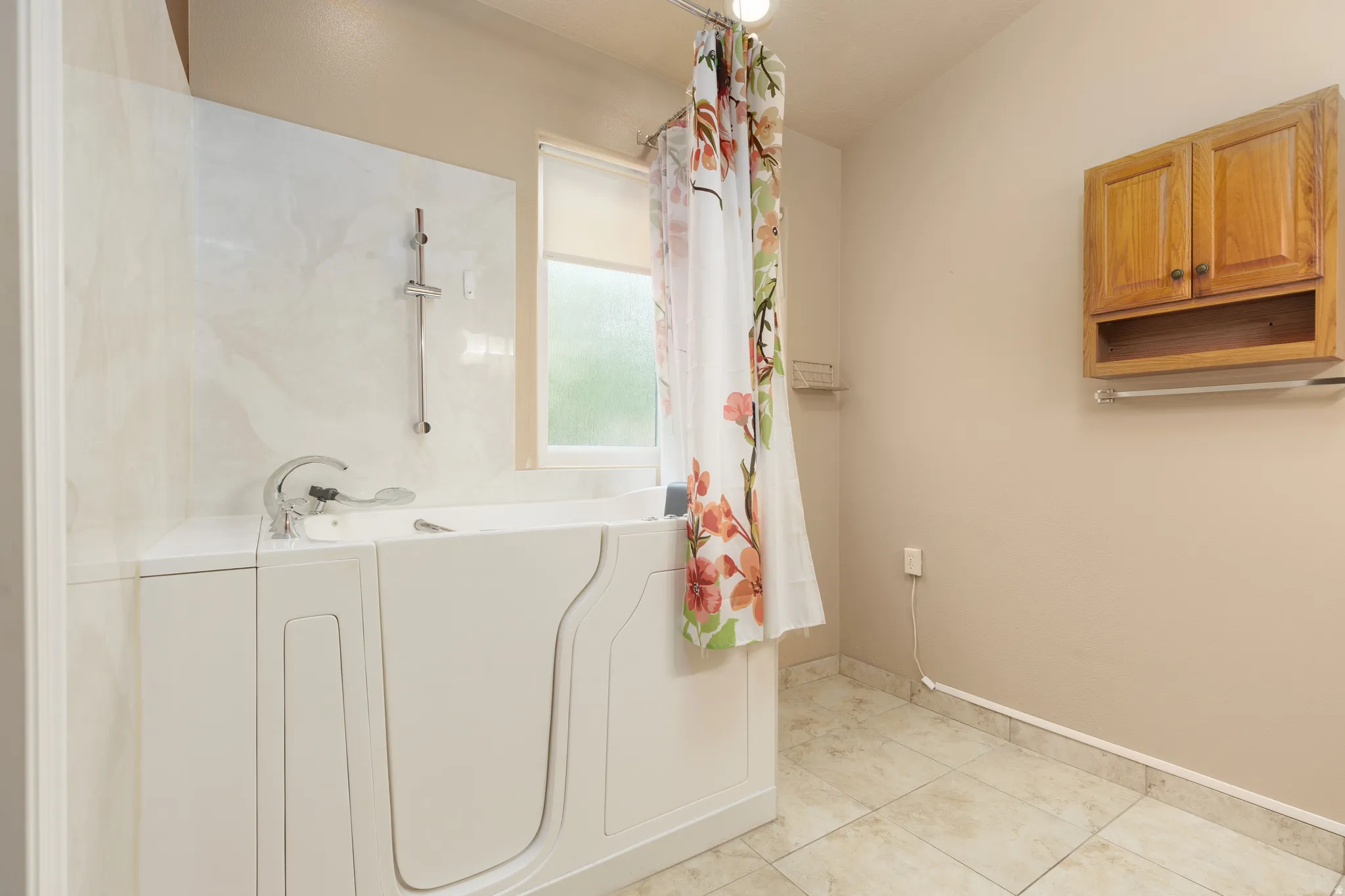 Walk-in tub with chrome fixtures and a handheld showerhead