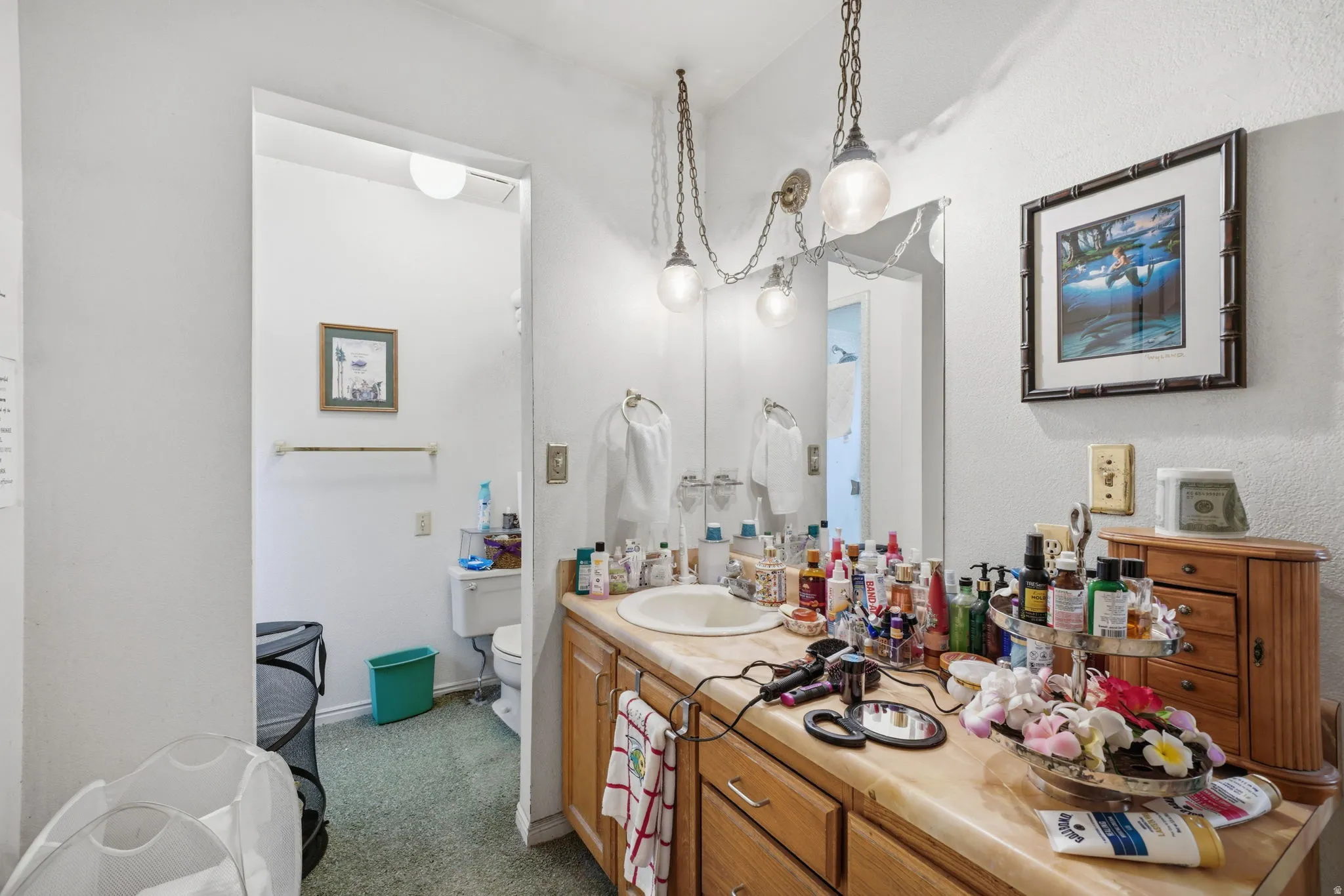Single vanity with an integrated sink and wood-finish cabinetry
