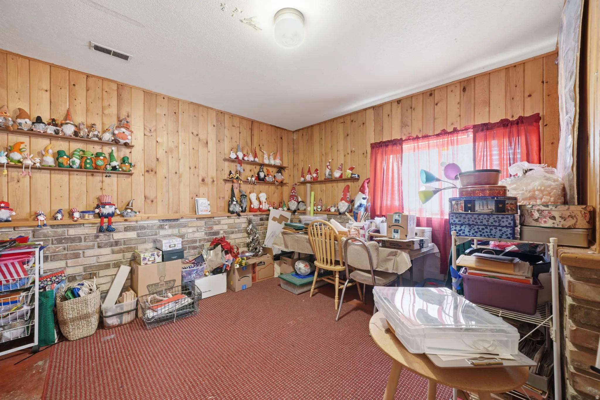 Wood paneling walls with an exposed brick lower wall