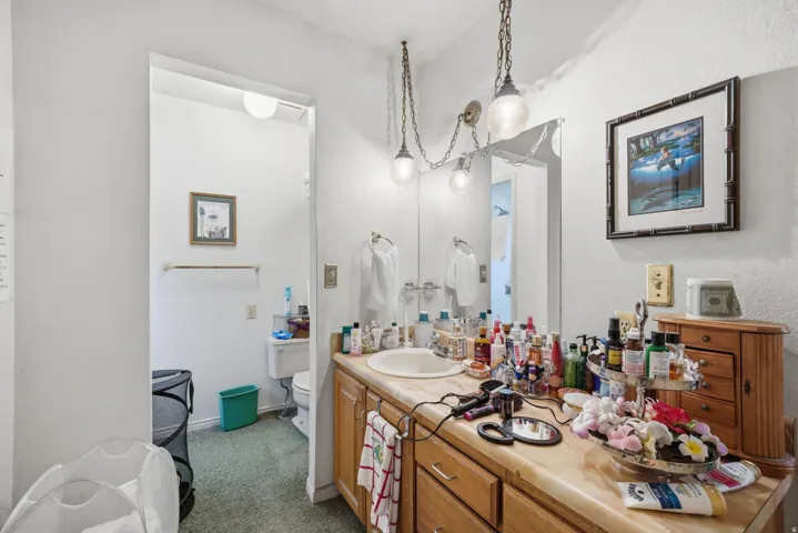 Single vanity with an integrated sink and wood-finish cabinetry