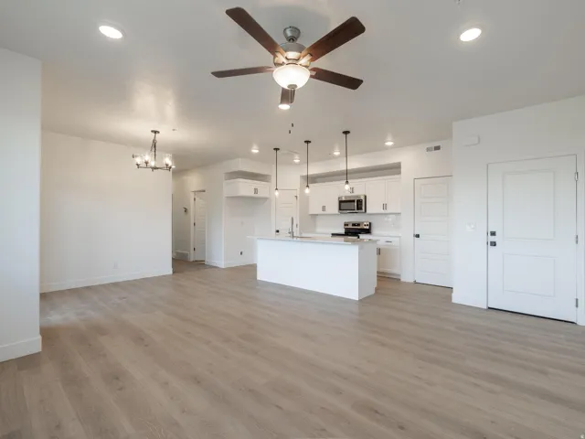 Open-concept living space with wood-finish flooring