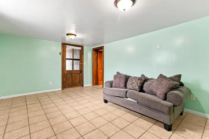 Tile flooring, light-colored walls, and two ceiling-mounted light fixtures