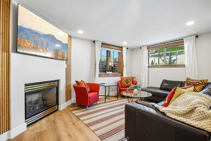 Integrated fireplace, wood-finish flooring, recessed lighting, and dual windows