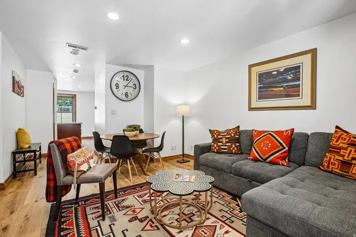 Wood-finish flooring throughout, recessed lighting, and a dining area with a round table