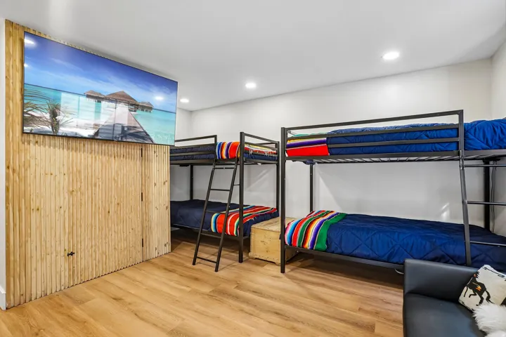 Recessed lighting, wood-finish flooring, and a mounted display screen