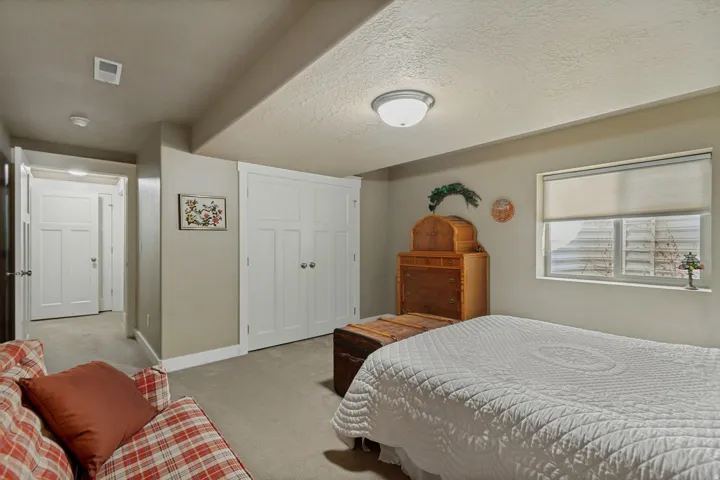 Recessed window with roller shade, ceiling-mounted light fixture, and two panel doors with circular hardware