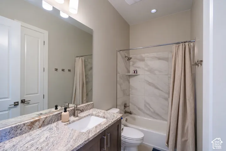 Vanity featuring a stone countertop and undermount sink