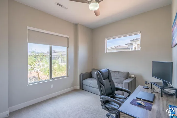 Neutral wall color, recessed lighting, ceiling fan, large window with roller shade, and a horizontal accent window