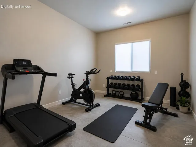 Recessed lighting, light-toned walls, and a large window with privacy treatment