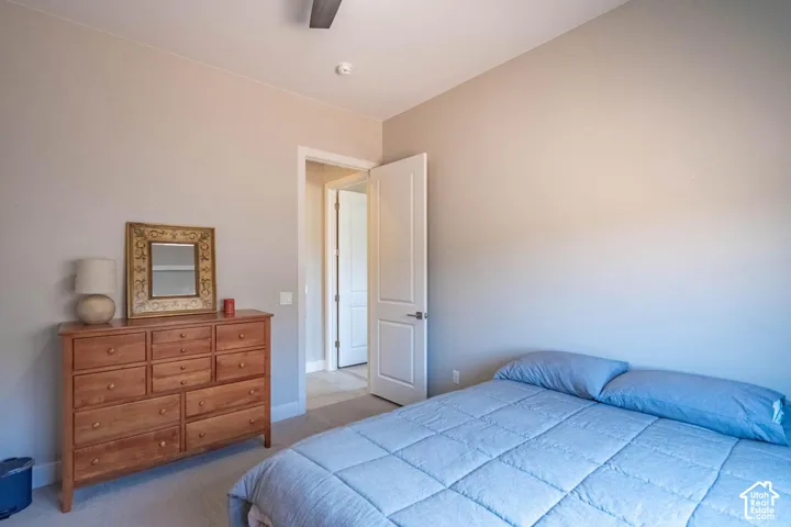 Recessed lighting, ceiling fan, neutral wall tones, carpet flooring, and a solid core door