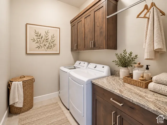 Built-in cabinetry with a stone-finish countertop, upper storage cabinets, and a hanging rod