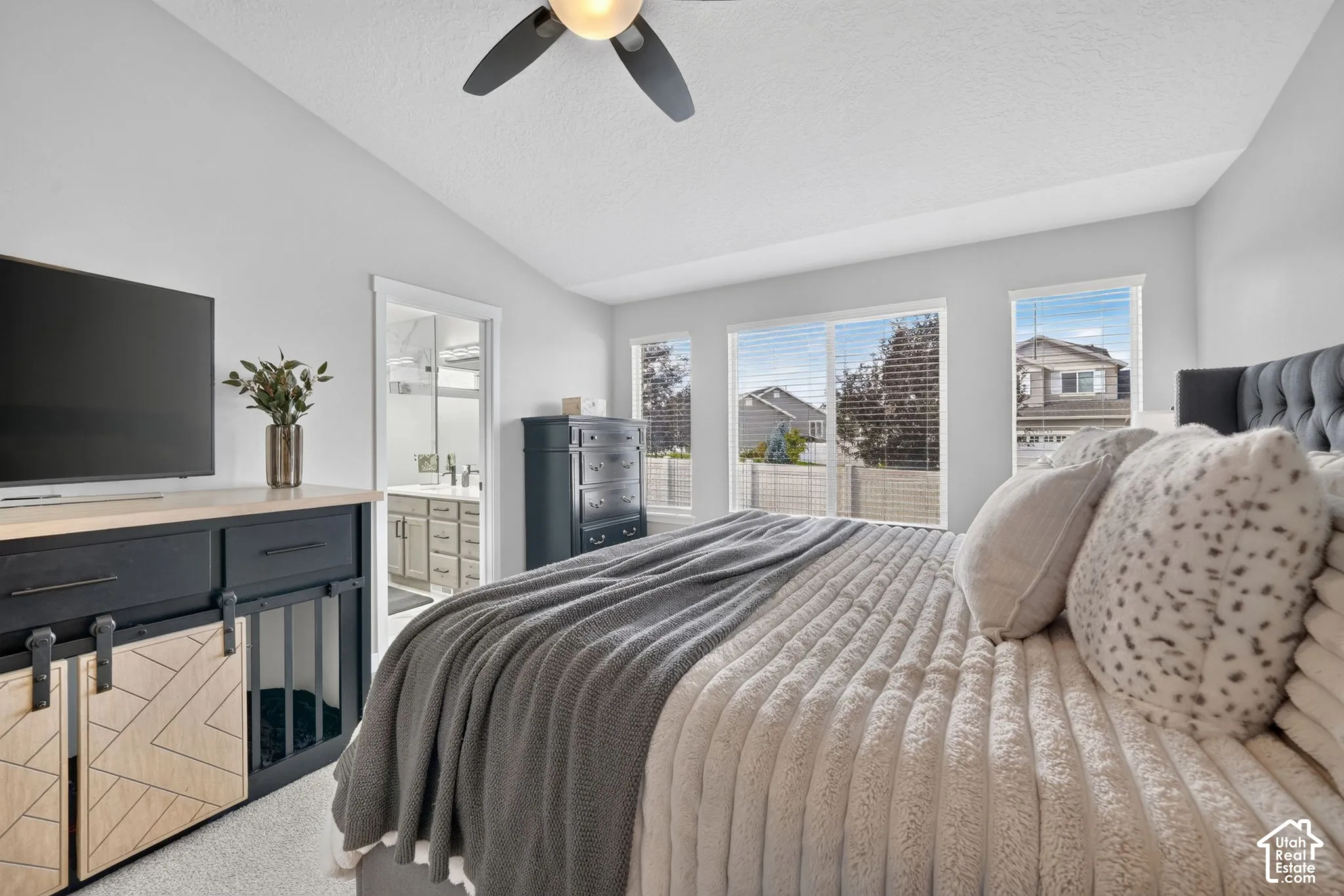 Vaulted ceiling, ceiling fan, multiple windows, built-in media console, en-suite bathroom access