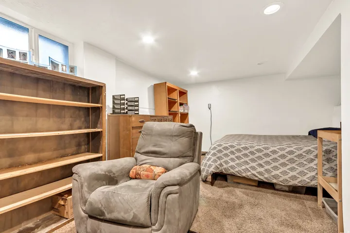 Recessed lighting, wall-to-wall carpeting, and white walls