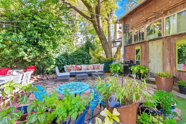 Patio area featuring brick pavers and lush plantings