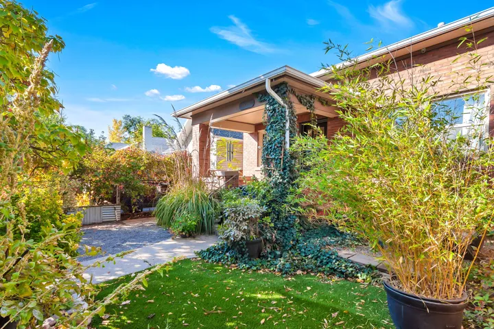 Brick exterior with a covered front porch and established landscaping
