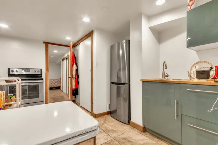 Kitchenette featuring stainless steel appliances, wood-finish countertop, and recessed lighting