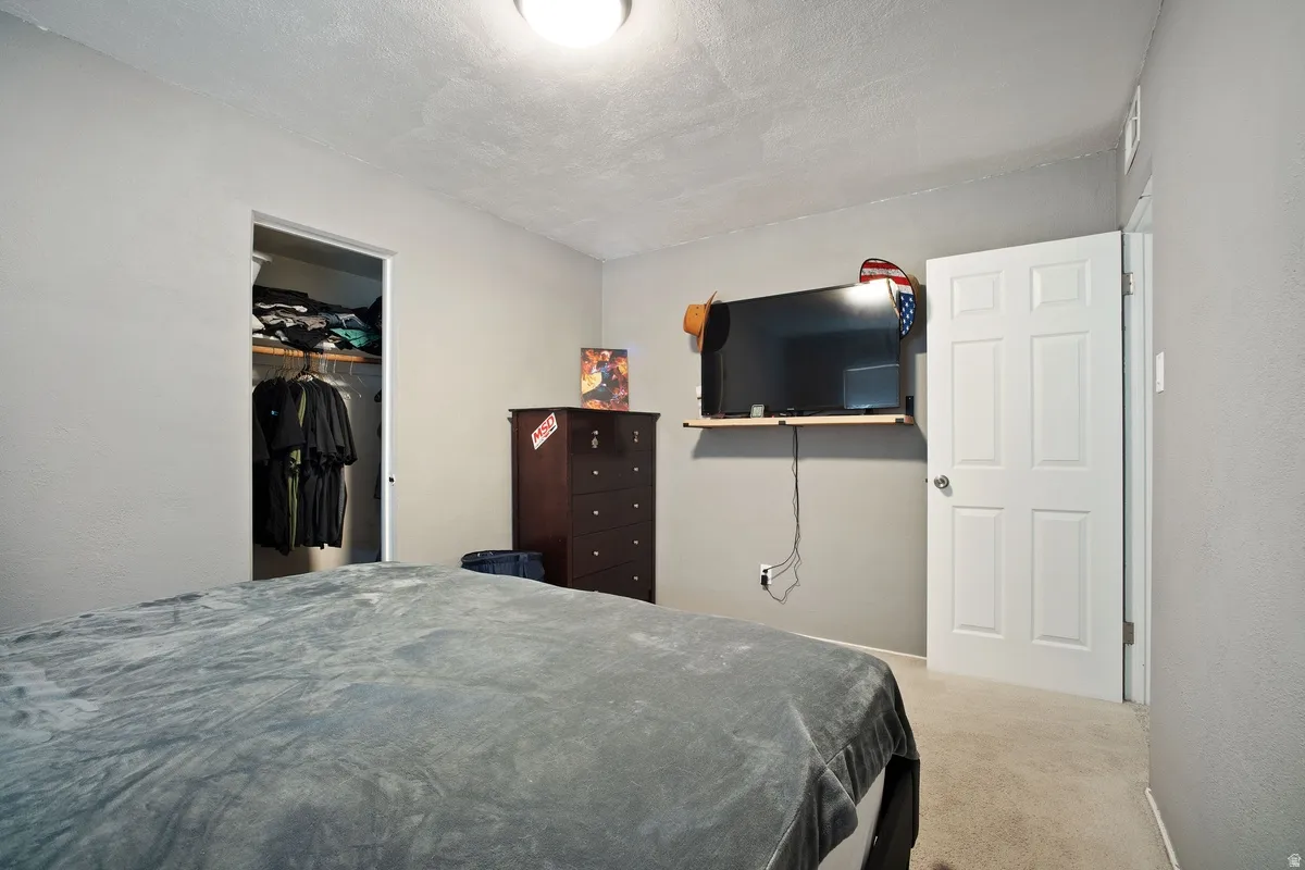 Wall-to-wall carpeting with light gray walls and a built-in closet