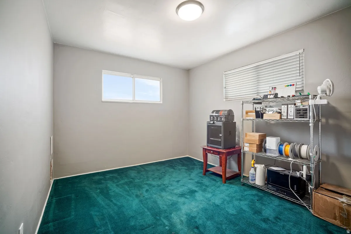 Room with a window and a ceiling-mounted light fixture
