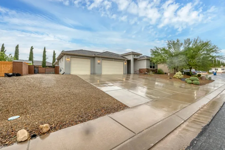 Contemporary exterior with a two-car garage, concrete driveway, and stone accents