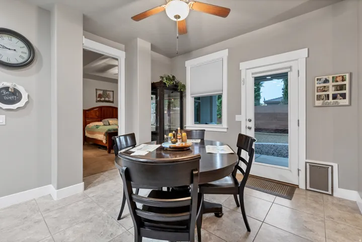 Tiled flooring throughout, with a ceiling fan overhead