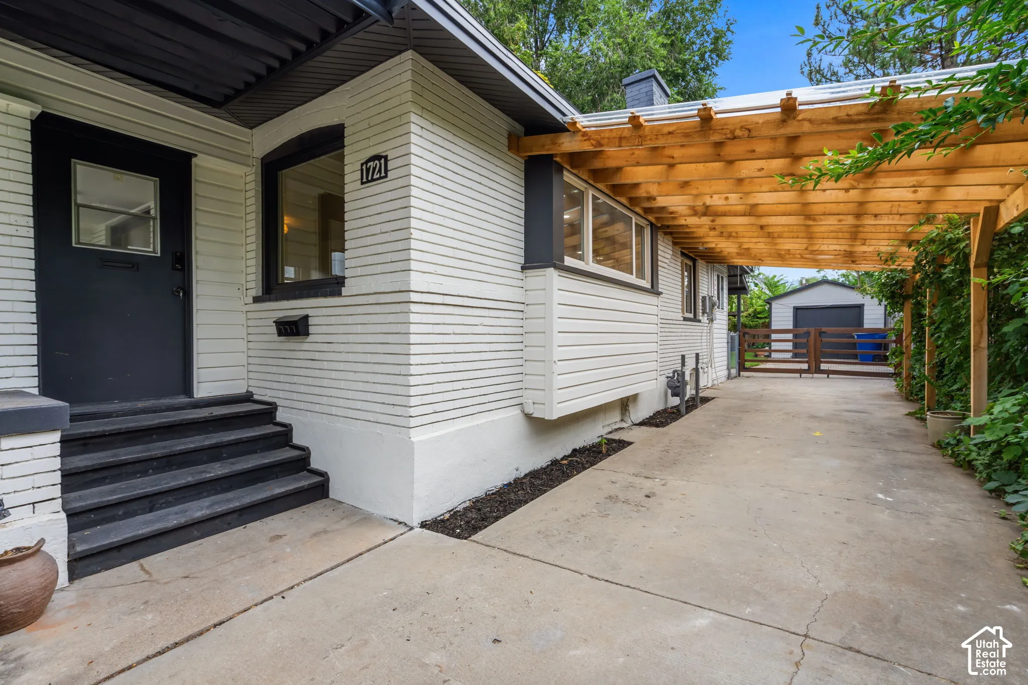 White brick exterior with dark trim accents