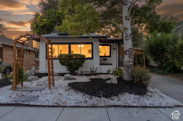 White brick exterior with dark trim windows