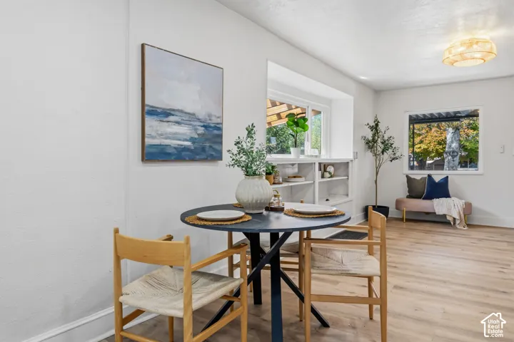 White walls, wood-finish flooring, recessed window shelving, and a modern ceiling light fixture