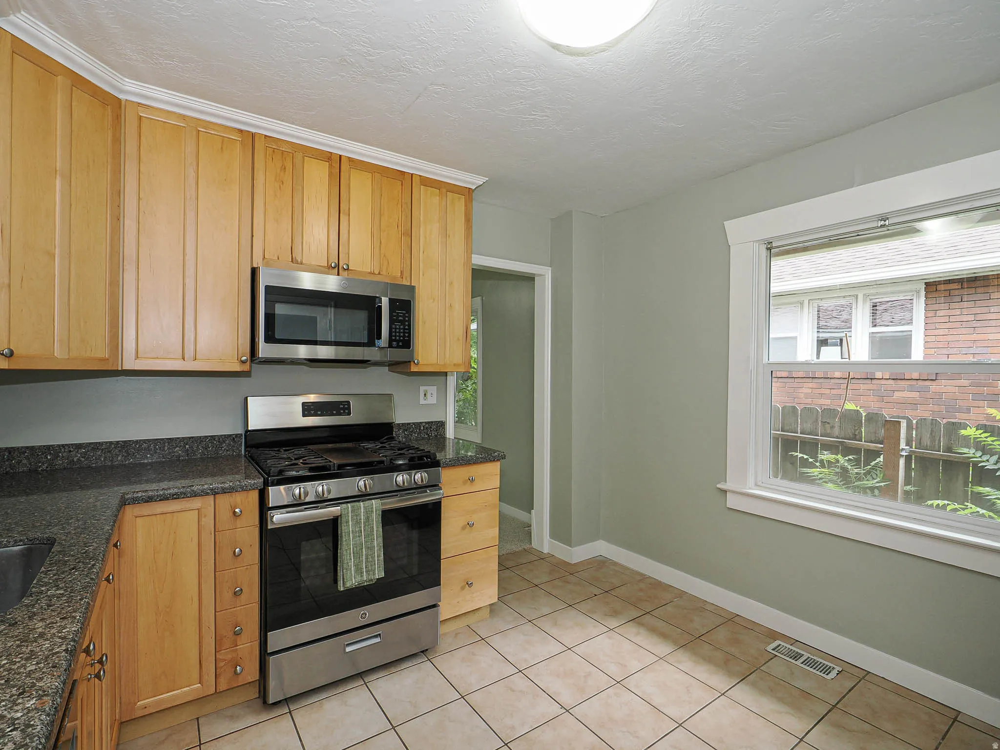 Gas range and dark stone countertops