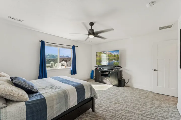 Recessed lighting, ceiling fan, and white paneled door