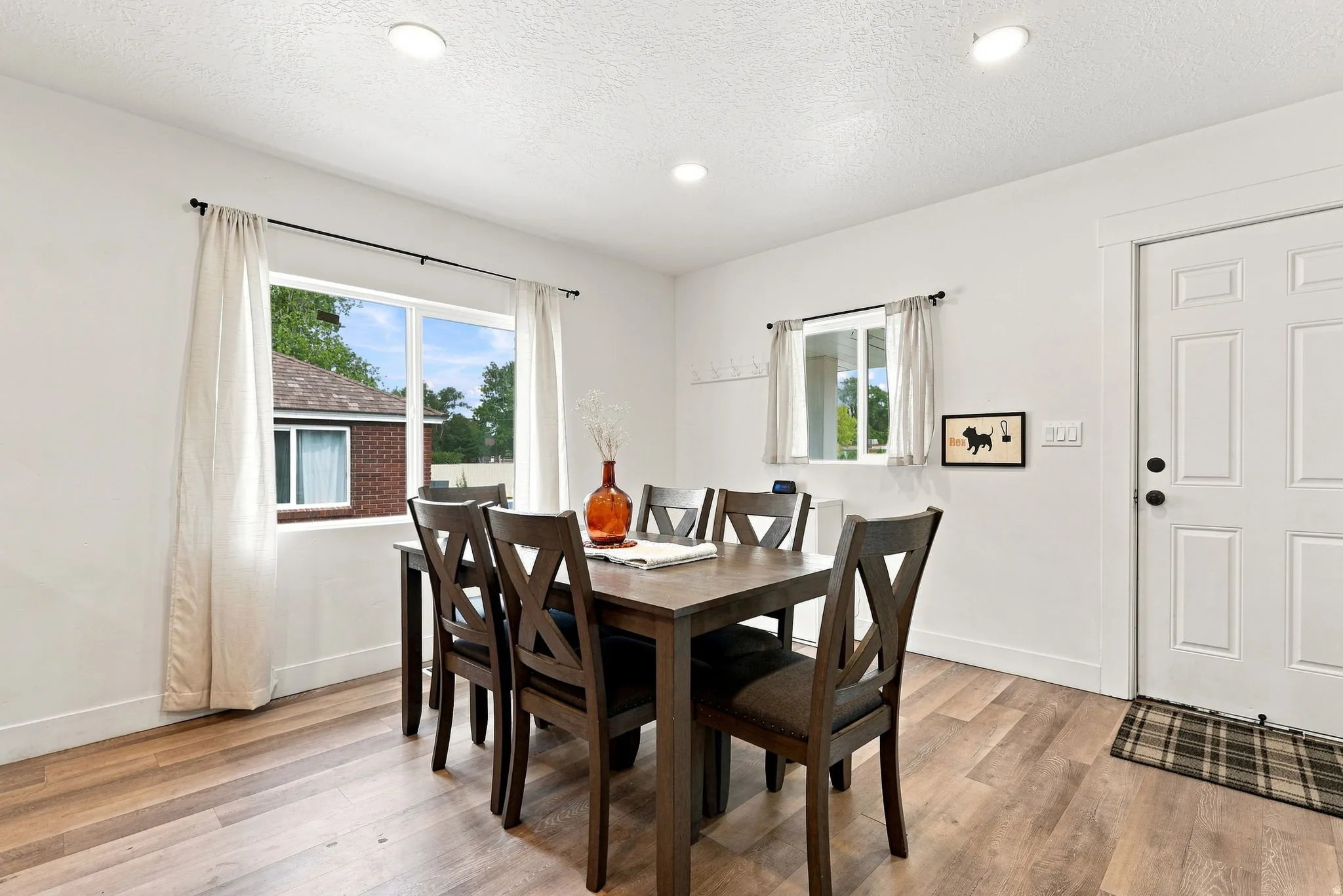Wood-finish flooring, recessed lighting, and a paneled entry door