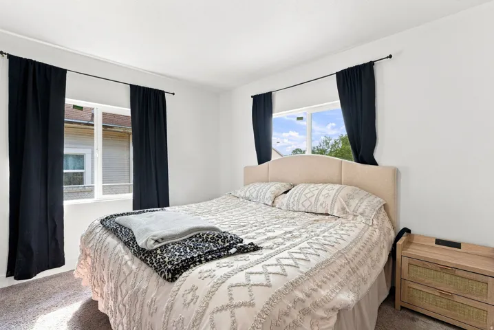 White walls with two pane windows and light-colored carpeting