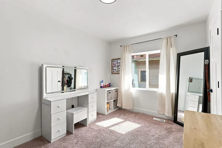 White walls, recessed lighting, and a single window with white trim