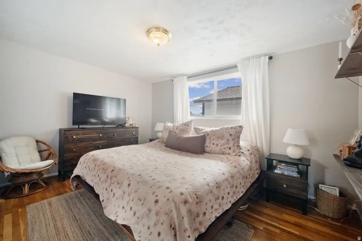 Hardwood flooring, natural light through a large window, and a built-in ceiling light fixture