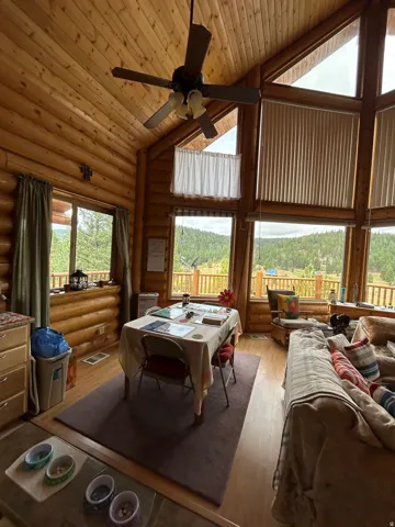 Vaulted ceiling with wood-finish paneling and exposed wood beams