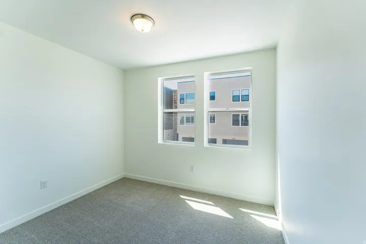 Neutral tone interior with carpet flooring, white walls, and a flush mount light fixture
