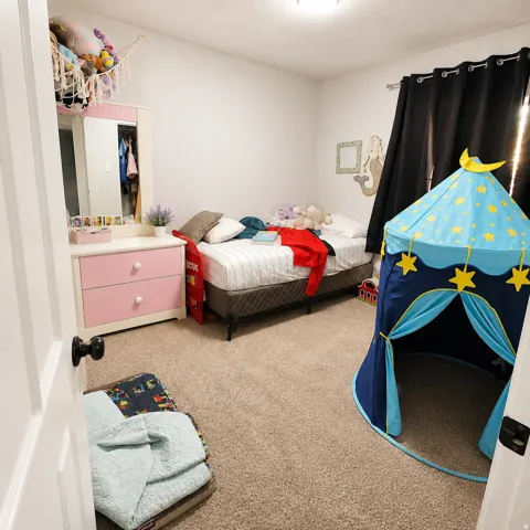Carpet flooring and a ceiling-mounted light fixture