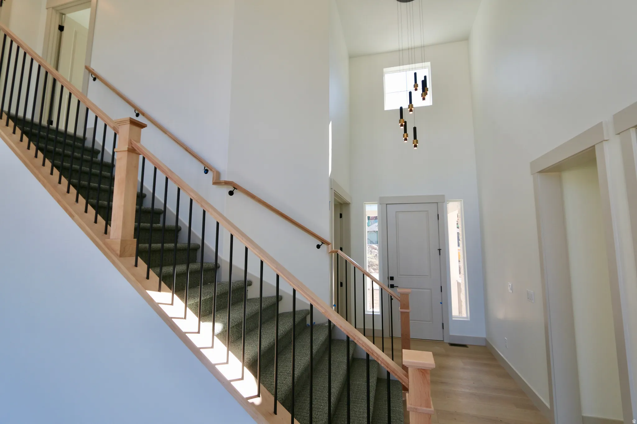 Two-story entry foyer with wood-finish flooring