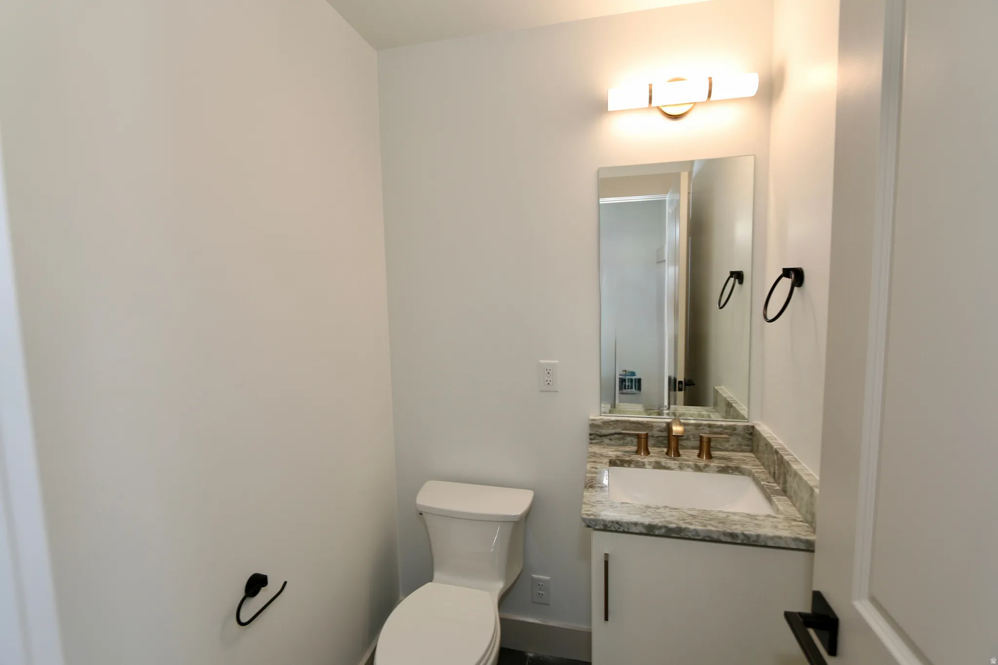 Guest bathroom with a granite countertop and undermount sink
