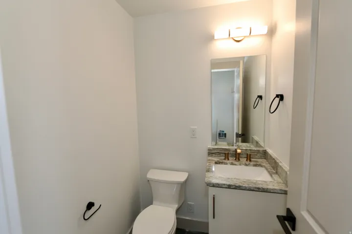 Guest bathroom with a granite countertop and undermount sink