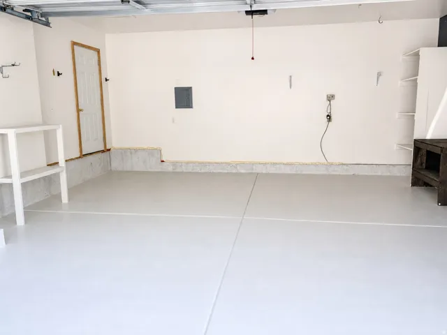 Attached garage with light gray flooring and white walls