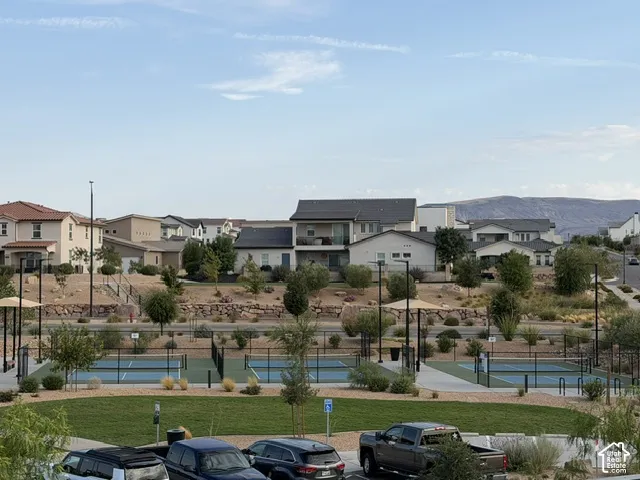Community green space with multiple pickleball courts and landscaped surroundings
